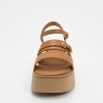 Vue de face de la sandale camel mettant en valeur l'alignement de ses multiples brides et l'épaisseur de sa plateforme beige.